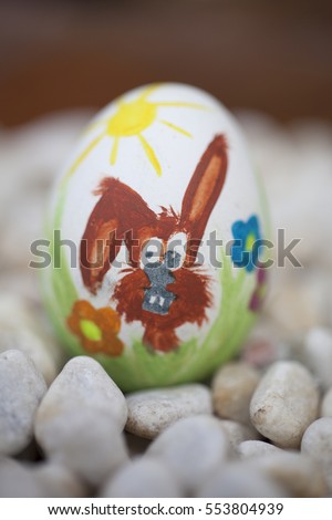 Detail of colorful painted Easter eggs with different forms and animals. In this case, a rabbit.