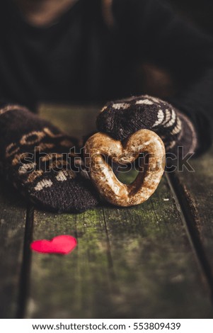 Gingerbread in the form of heart in hands
