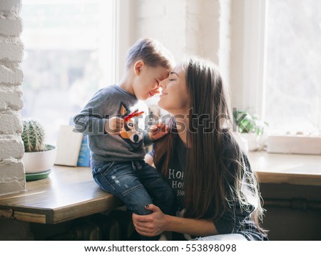 mother kissing her little son Royalty-Free Stock Photo #553898098