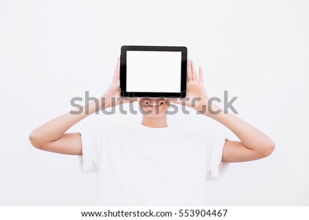 girl with a smile shows tablet. On a white background.