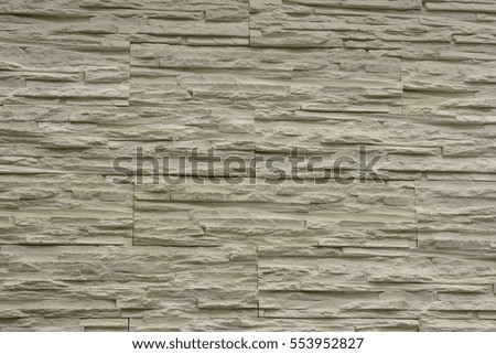 Stone wall texture background in the light of ancient natural cream beige brown