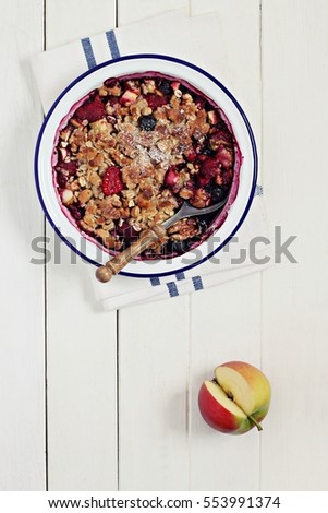 Apple-berry crumble with oatmeal and nuts crunch.Clean eating concept.Rustic style