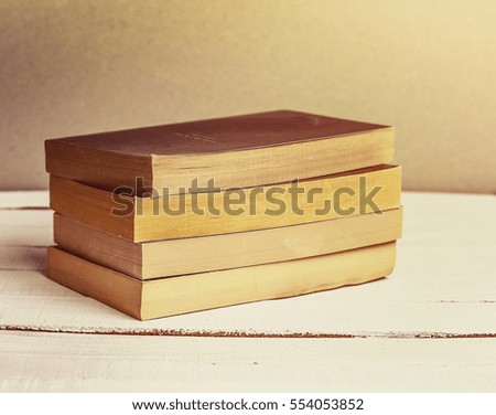 Old Books Background. Books on wooden shelf. Copy space. Vintage style toned image