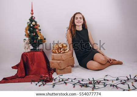 Mom and daughter decorate Christmas tree. give gifts. pictures. good time
