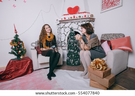Mom and daughter decorate Christmas tree. give gifts. pictures. good time