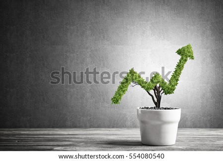Small plant in pot shaped like growing graph Royalty-Free Stock Photo #554080540