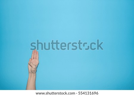 Finger symbol isolated on blue background
