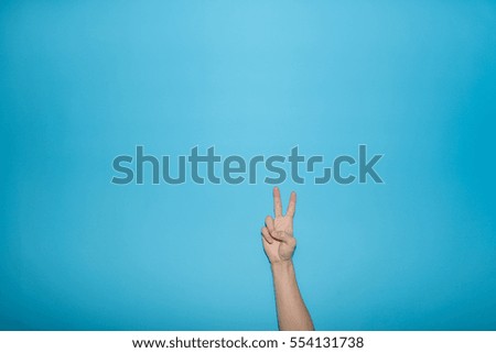Finger symbol isolated on blue background,Gesturing 2