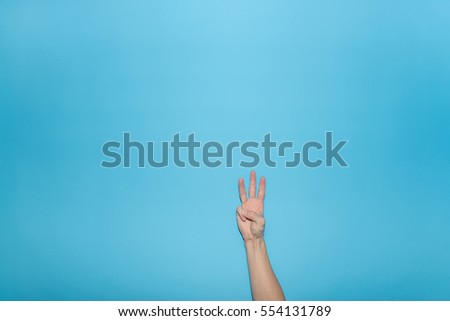 Finger symbol isolated on blue background,Gesturing 3

