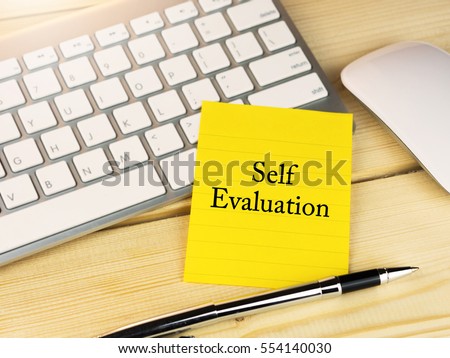 Self evaluation on sticky note on work desk Royalty-Free Stock Photo #554140030