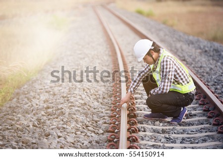 Railroad workers checking railways Royalty-Free Stock Photo #554150914