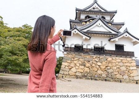 Woman taking photo on Hikone castle
