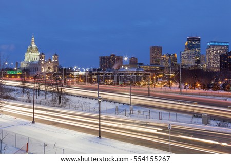 A Long Exposure Wide Angle Shot of the Modern and Classical Architecture of the Minneapolis Skyline during Twilight Rush Hour