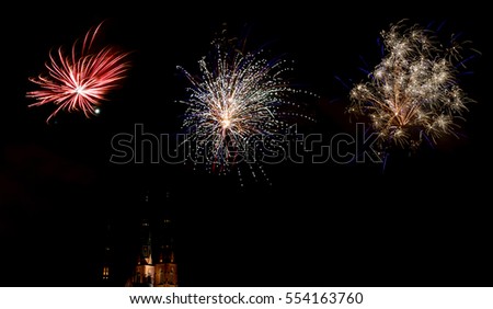 Celebration of the new year with fireworks in Sweden. The church in Uppsala in the background