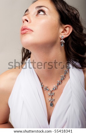 Beautiful girl demonstrate necklace and earring