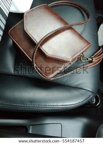 Close up picture of leather lady bag on car seat. 