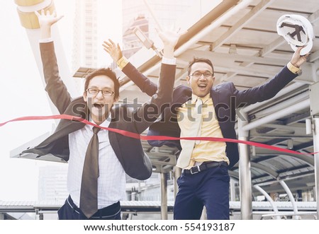 Dramatic Moment Businessman and partner Winning crosses the finish line,Businessman running into finish line achieving accomplishment,Successful entrepreneurs are happy their new victory.