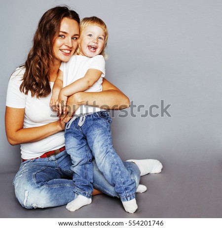 young pretty stylish mother with little cute daughter hugging, h