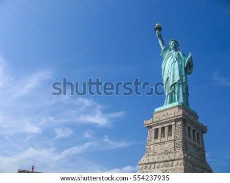 A tourist taking photo of the Statue of Liberty, New York city, USA