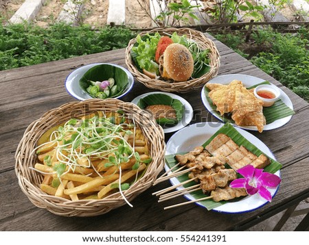 A fusion food set ,french fries and hamburger, barbecue,fried crisp on wooden table background,hipster food style decoration.