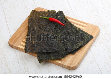 Spicy Nori seaweed sheets with pepper on wood