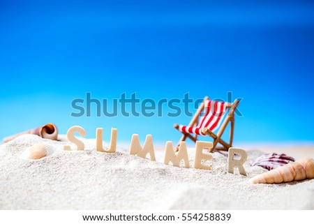 Summer holiday decoration with wooden text, beach chair and sea shall on white sand beach with tropical blue sea and clear blue sky,Image For Love summer holiday vacation travel Concept.