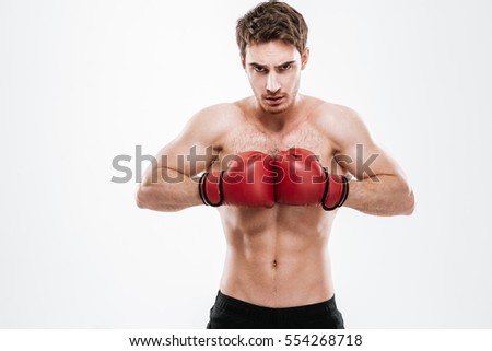 Picture of attractive man boxer standing over white background. Look at camera.