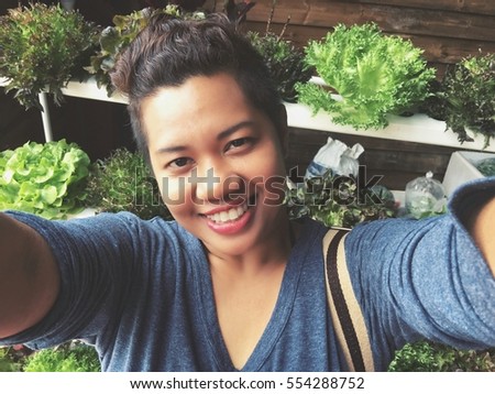 Woman taking a selfie with vegetables