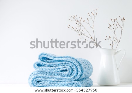 Minimal elegant composition with blue scarf and white vase