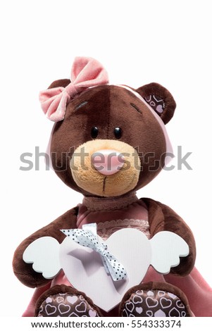 Plush toy bear sitting with heart a pink heart on isolated white background. Valentine day