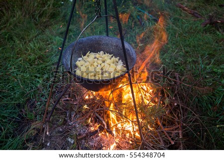 Outdoor cooking on campfire
