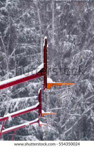 Snow covered basketball playground. Snow covered basketball hoop