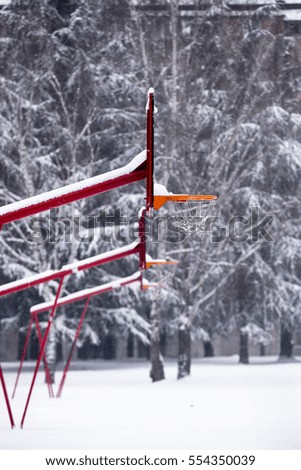 Snow covered basketball playground. Snow covered basketball hoop