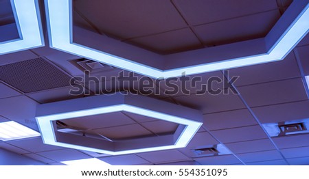celling lamps as hexagons with light inside it with squares as chandeliers, violet purple lilian geometric hexagon office lamps in big work room