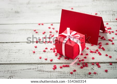 Valentines day background. Postcard confession of love. Red greeting card and gift.