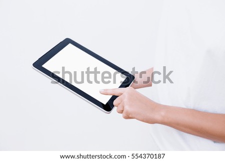 Girl uses a tablet .On a white background. Close up.