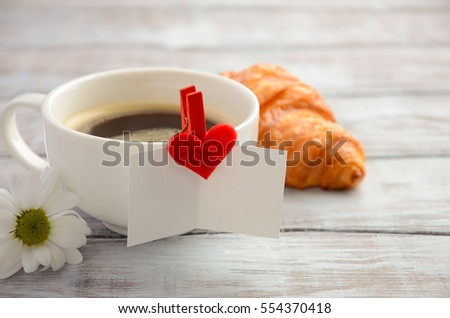 Cup of fresh morning coffee with Valentine's day card, copy space