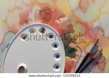palette with brushes on poppies watercolor background