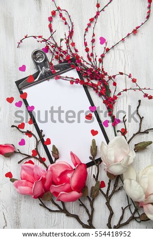 Valentine background with coloured hearts and flowers on white wooden background