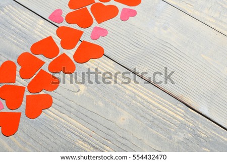 set of paper valentine red hearts in line on grey vintage wooden background, copy space