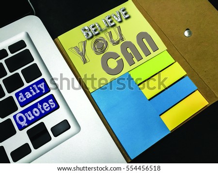 Daily quotes with text: "Believe You Can" on a yellow sticky note. Inspirational & motivational concept.