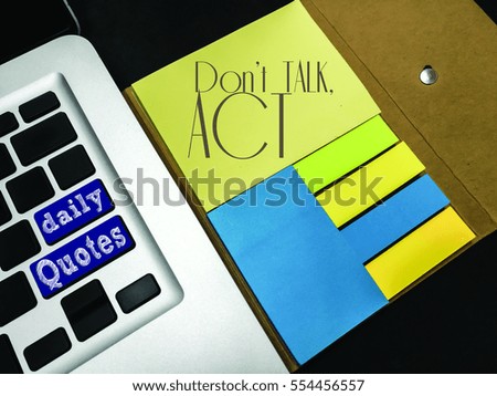 Daily quotes with text: "Don't Talk, Act" on a yellow sticky note. Inspirational & motivational concept.