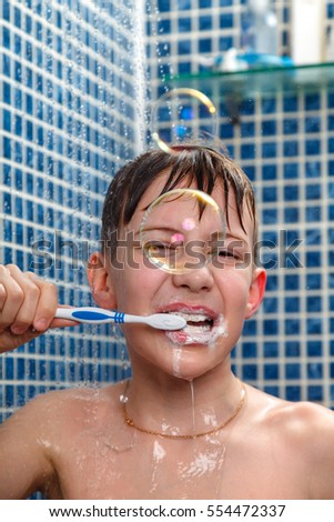 teen brushes her teeth in the shower
