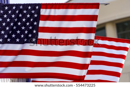American flag in front of a city