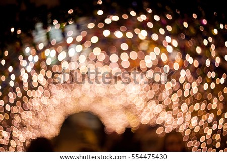 Christmas background. Celebration background. Birthday background. Festive abstract background with bokeh defocused lights and stars, yellow, gold, orange, purple, green, blue colors