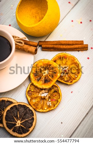 
vertical picture. cup of coffee, cinnamon sticks, cloves Dried orange, coconut, diagonal frame production