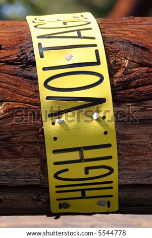 high voltage sign on removed broken utility pole