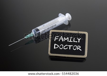 Medical Concept: Family Doctor with syringe on blackboard