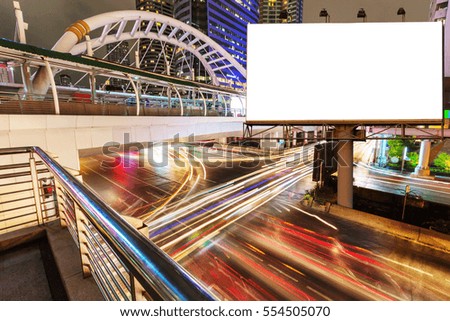 Blank billboard with light trails, street and urban in the night - can advertisement for display or montage product or business.