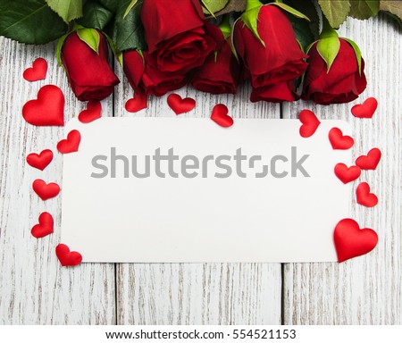 Roses and red  hearts   on a white wooden background